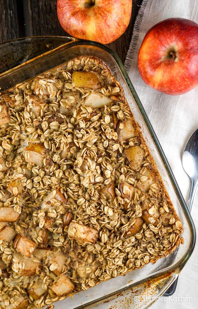 Baked oatmeal with apples and cinnamon in a glass baking dish.