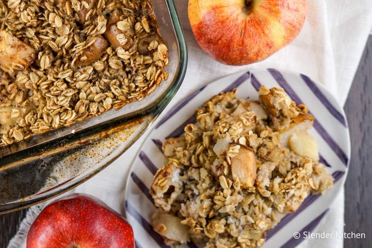 Baked oatmeal with apples and cinnamon in a glass baking dish.