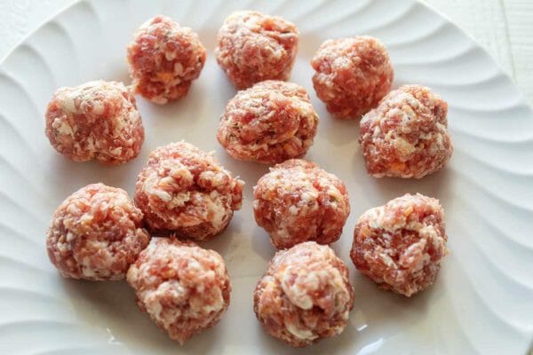 Form round sausage meatballs for slow cooker