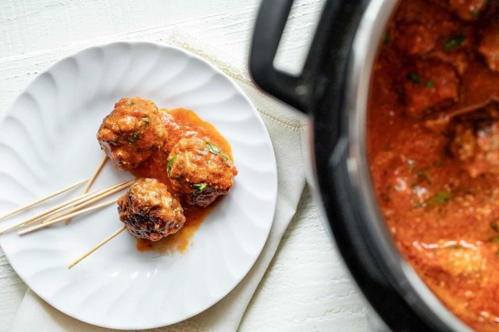 Cheese-stuffed sausage balls on a plate