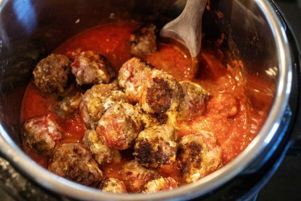 Put browned sausage balls into the slow cooker pot