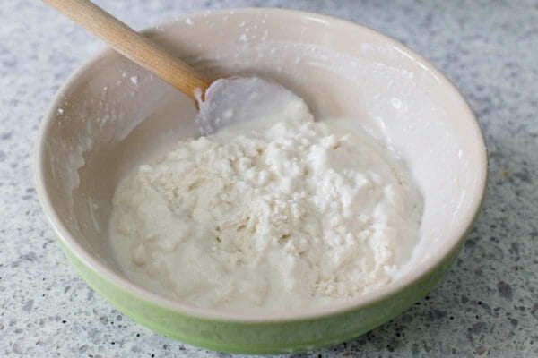 Flour in a green bowl to make dumplings for chicken and dumplings.