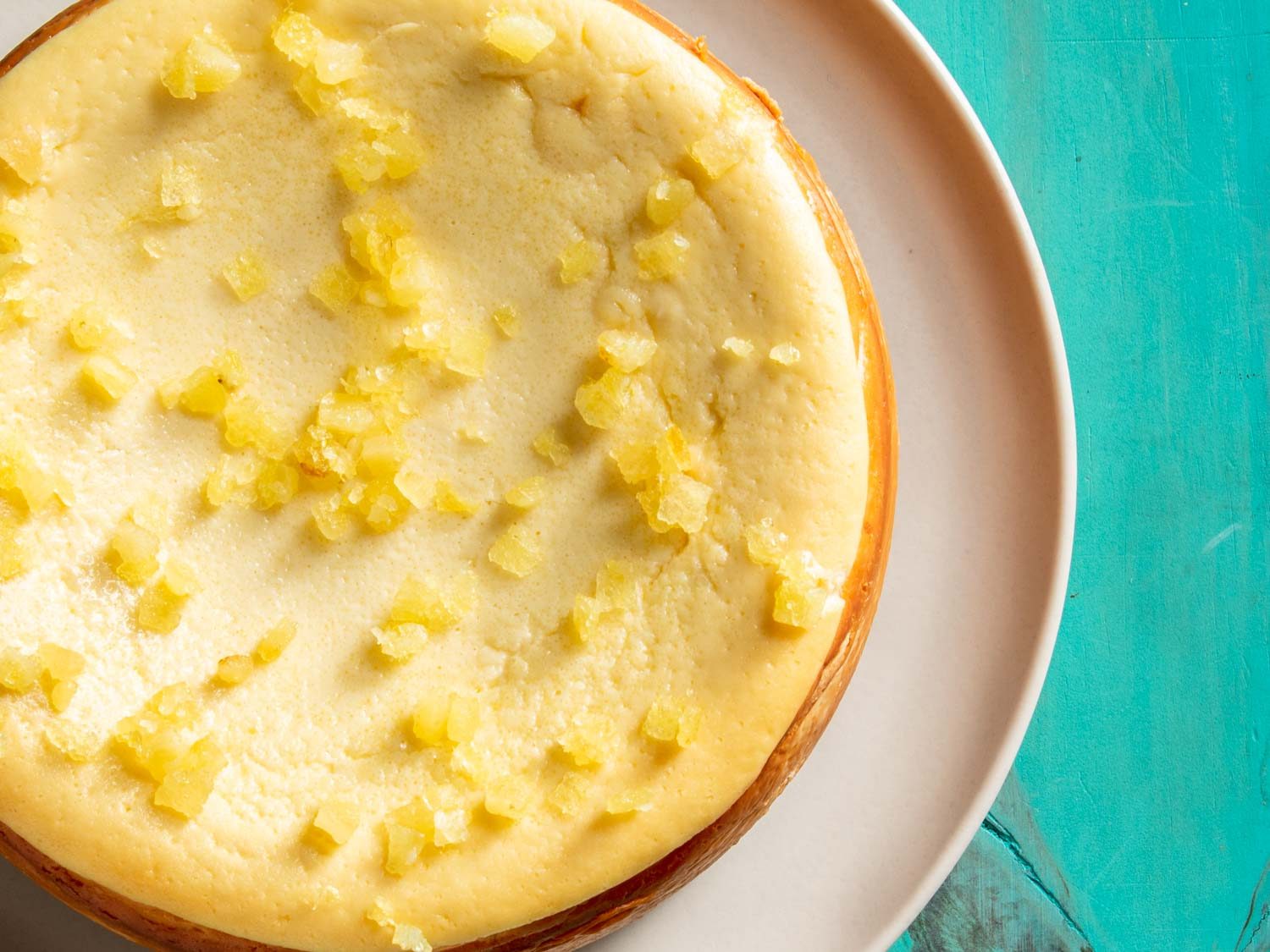 overhead shot of a lemon cheesecake topped with candied lemon peel