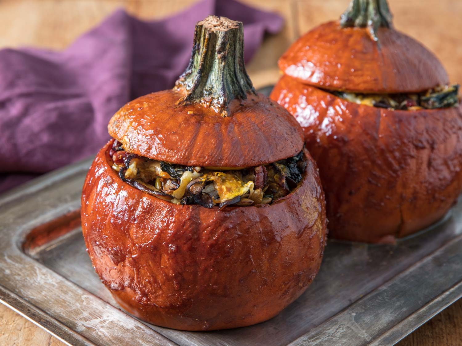 Stuffed pumpkins with Gruyere, mushrooms, kale (for Thanksgiving and holidays), glazed and tops on.