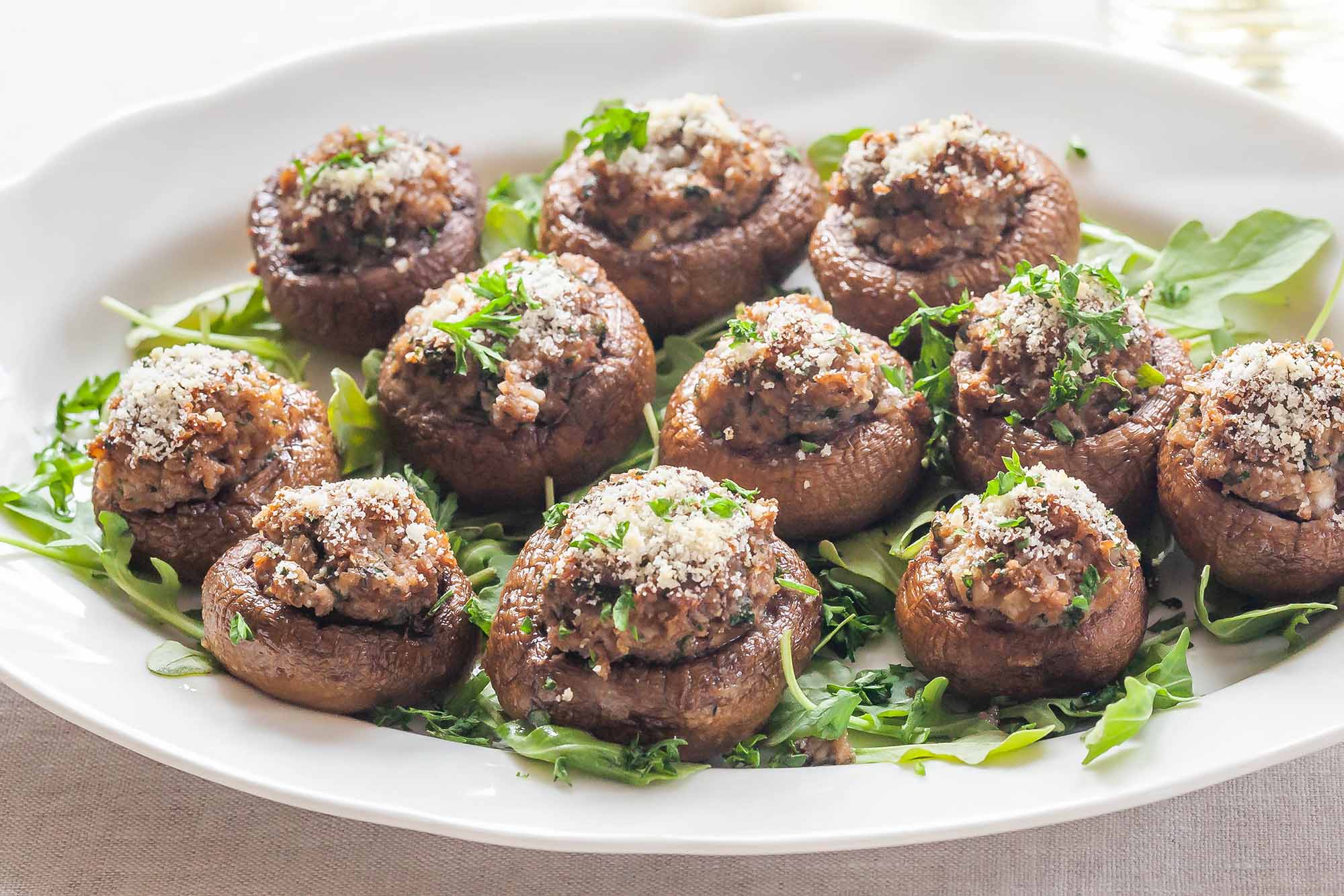 Stuffed mushroom caps on an appetizer tray