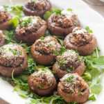 baked stuffed mushroom caps on a serving platter