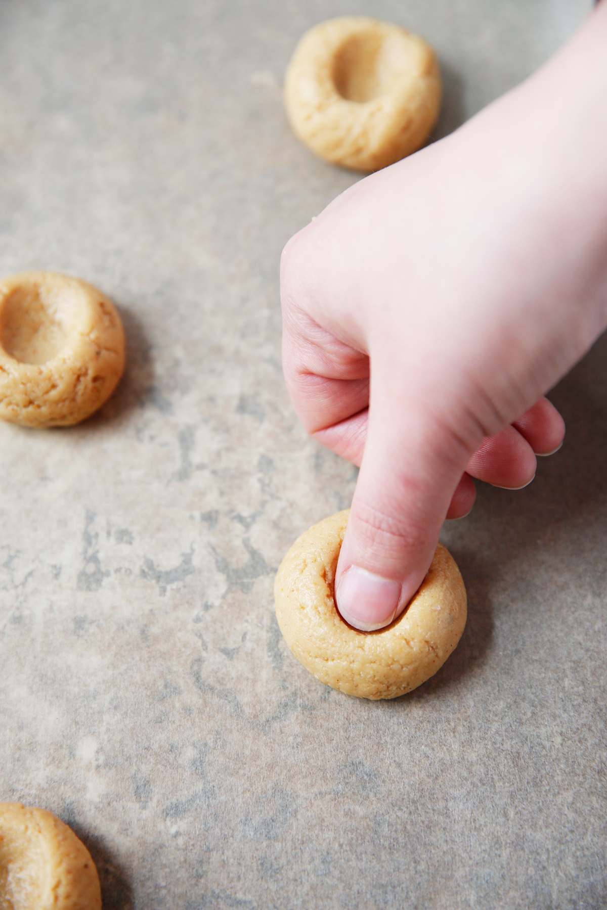 Making an indentation in gluten free peanut butter thumbprints