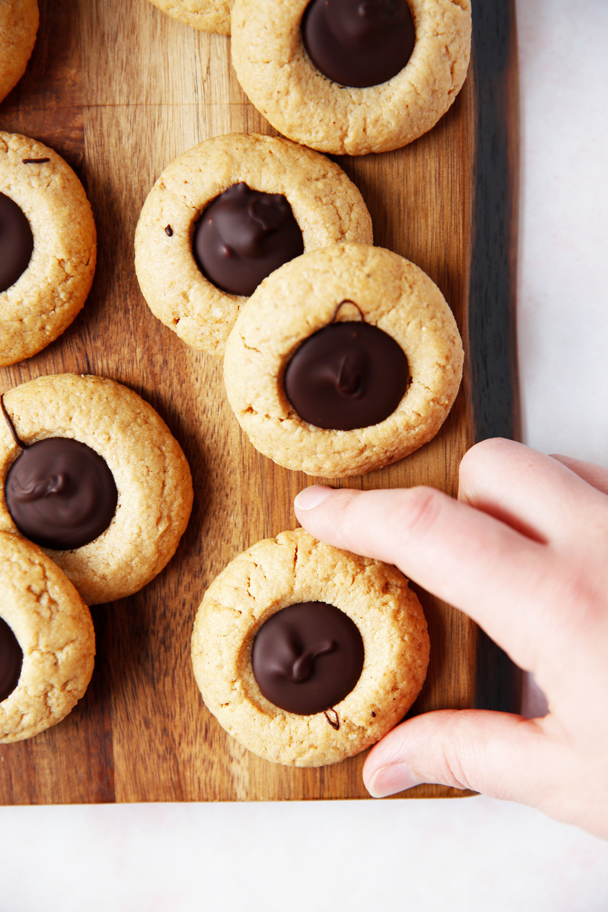 Gluten free peanut butter blossoms on a board.