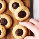 Gluten free peanut butter blossoms on a board.