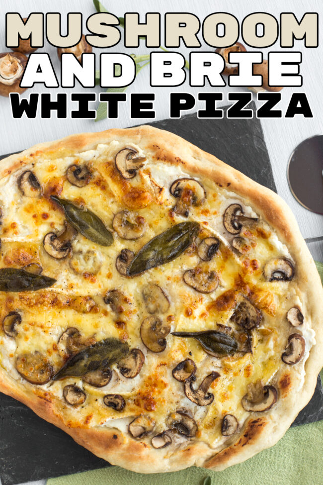 A white pizza topped with mushrooms and whole sage leaves.
