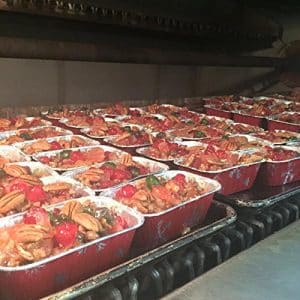 Trays of food in the oven.