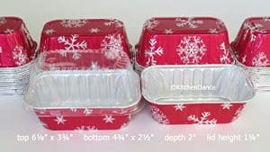 A set of red and white foil food containers with snowflakes on them.