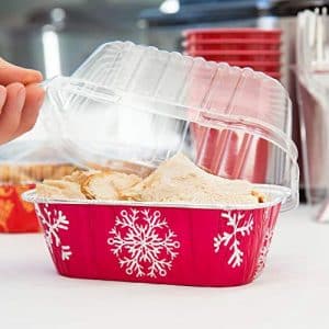 A person is putting food into a plastic container.